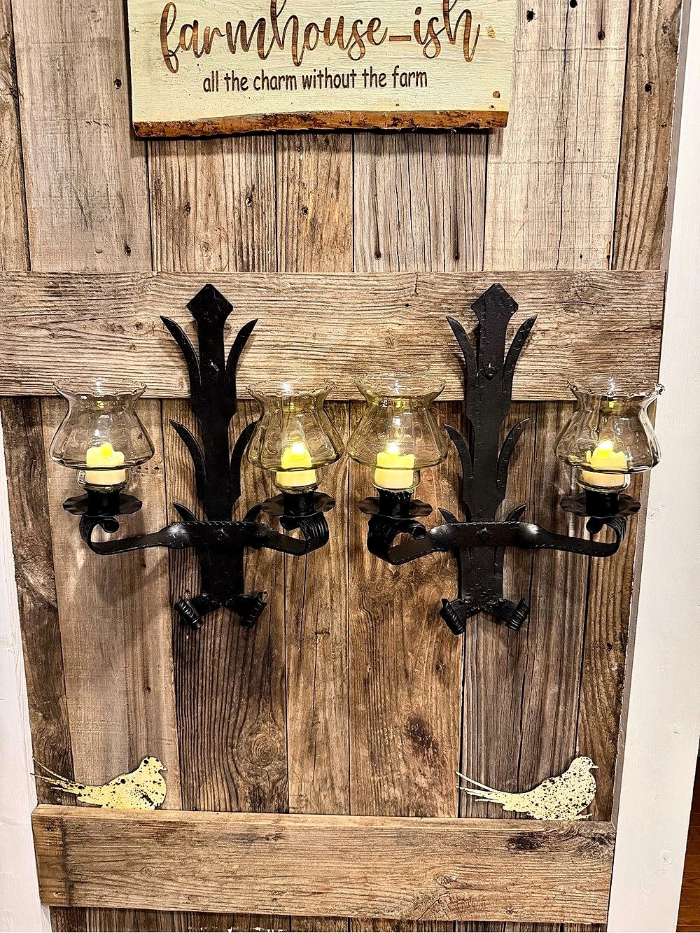 Pair of wrought iron double-arm black and glass candle wall sconces